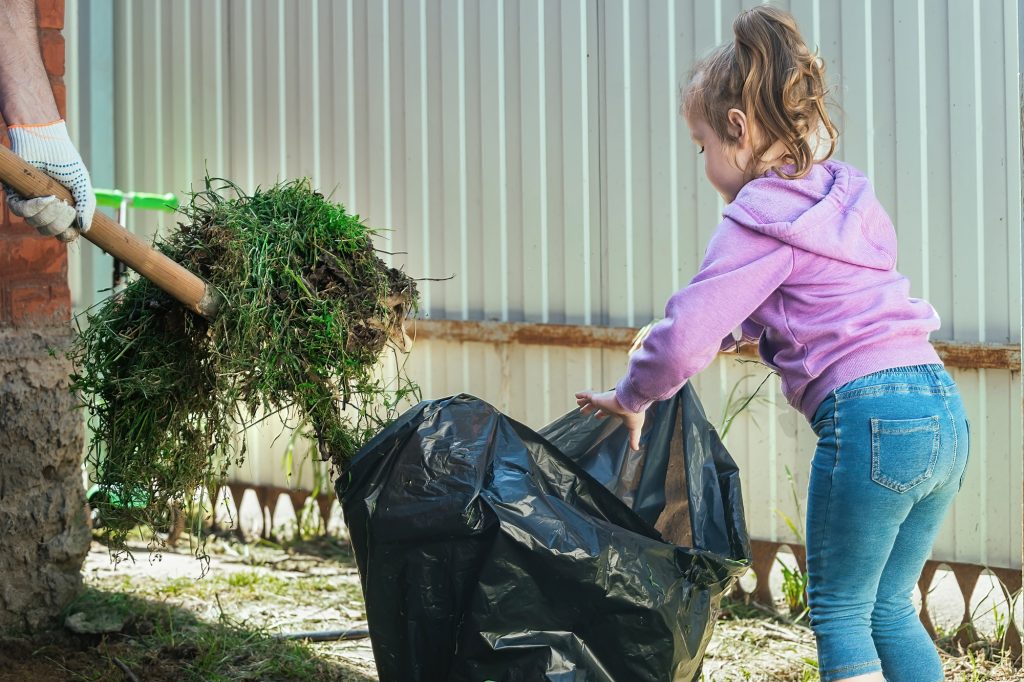 family cleans up their backyard